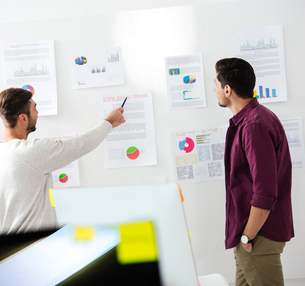 back-view-of-young-businessmen-discussing-new-marketing-strategy-in-office.jpg